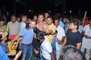 Malkeet Brawler celebrates his victory with wrestling fans.