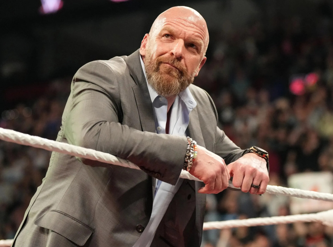 Triple H mentoring young WWE wrestlers inside a training facility